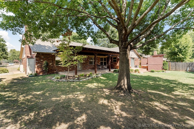 exterior space with a front yard and a patio area