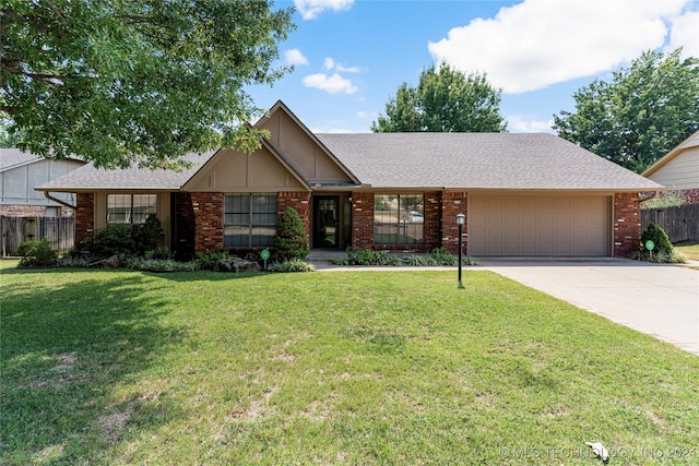 single story home featuring a front yard and a garage