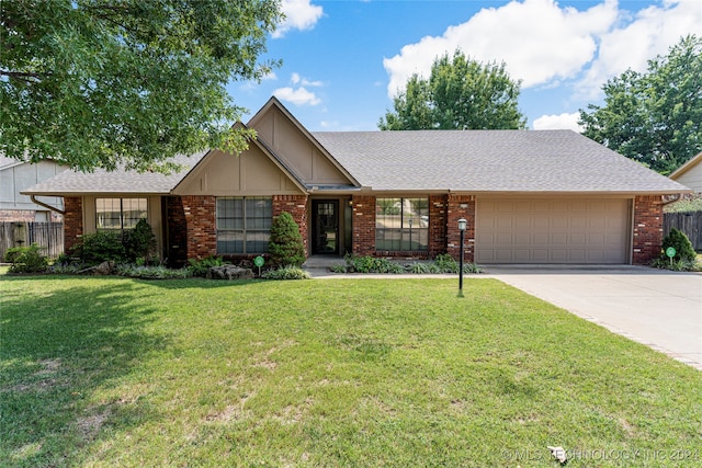 single story home featuring a garage and a front yard