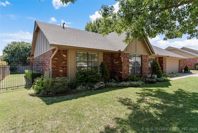 ranch-style home featuring a garage and a front yard