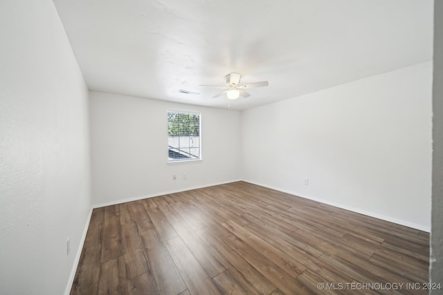 empty room with hardwood / wood-style floors and ceiling fan