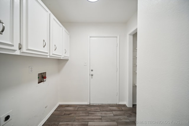 clothes washing area featuring hookup for a washing machine, electric dryer hookup, dark wood-type flooring, and cabinets