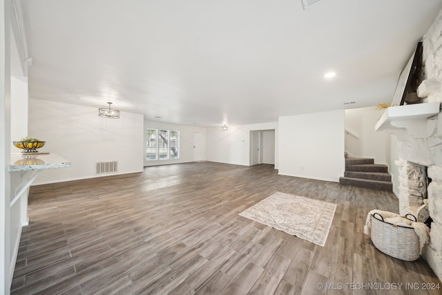 unfurnished living room with hardwood / wood-style floors and a fireplace