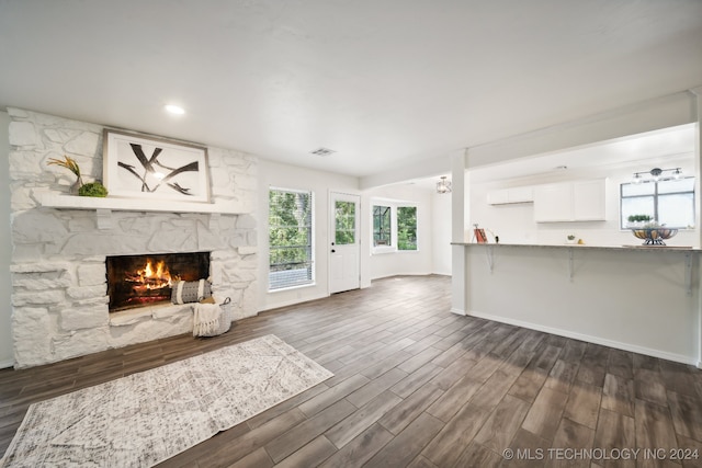 unfurnished living room with dark hardwood / wood-style floors and a fireplace