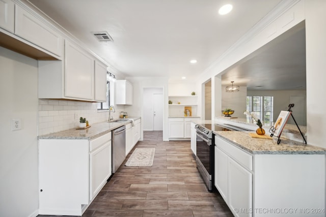 kitchen featuring white cabinets, appliances with stainless steel finishes, and light hardwood / wood-style flooring