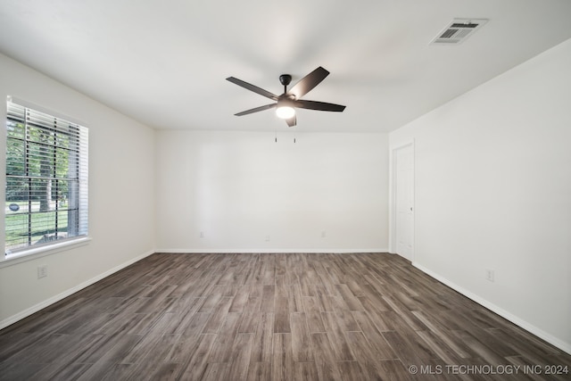 unfurnished room featuring ceiling fan and dark wood-type flooring