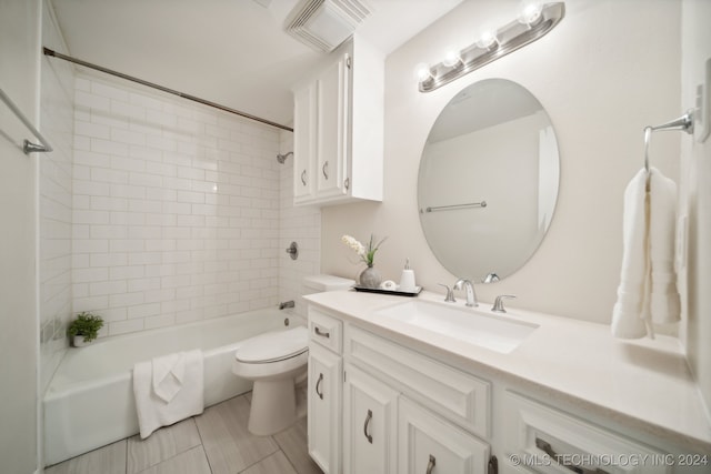 full bathroom with vanity, tile patterned flooring, tiled shower / bath, and toilet