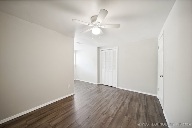 empty room with ceiling fan and dark hardwood / wood-style floors