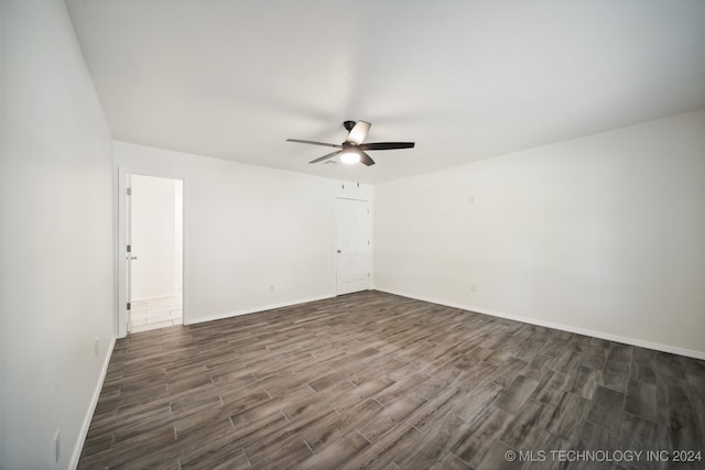 unfurnished room with dark hardwood / wood-style flooring and ceiling fan