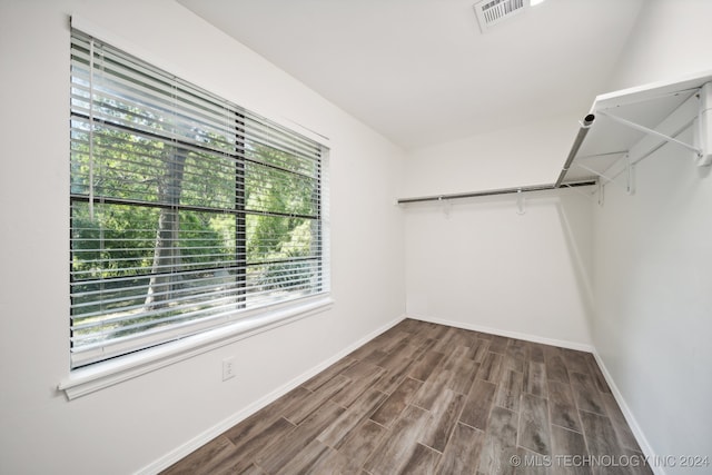 walk in closet featuring dark wood-type flooring