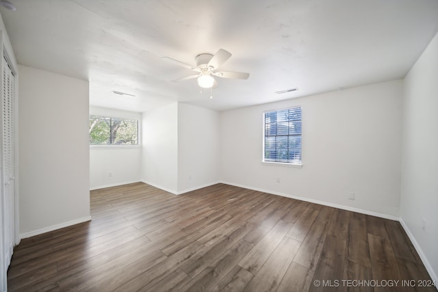 unfurnished room featuring ceiling fan and dark wood-type flooring