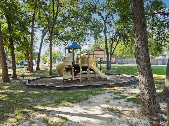 view of playground with a lawn