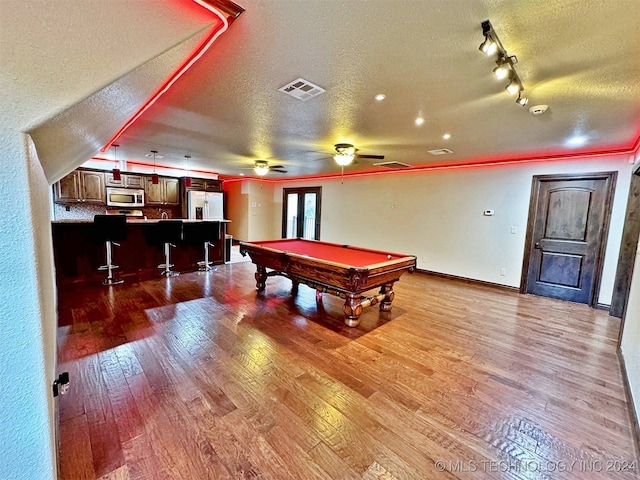 game room with a textured ceiling, ceiling fan, pool table, and wood-type flooring