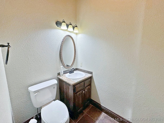 bathroom featuring vanity, toilet, and tile patterned flooring