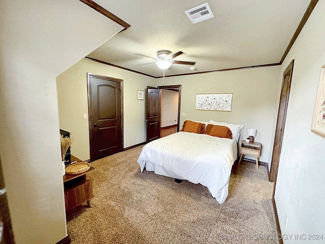 carpeted bedroom featuring a textured ceiling, crown molding, and ceiling fan