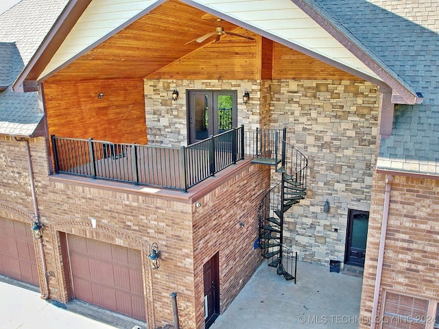 view of side of home featuring a balcony, ceiling fan, and a garage