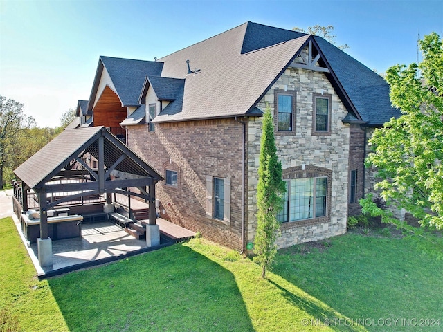 back of house featuring a lawn, a patio, and a gazebo