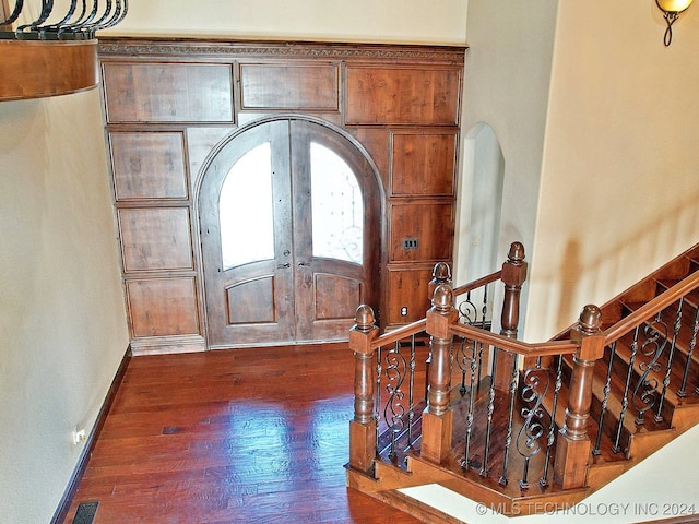 entryway with dark wood-type flooring and french doors