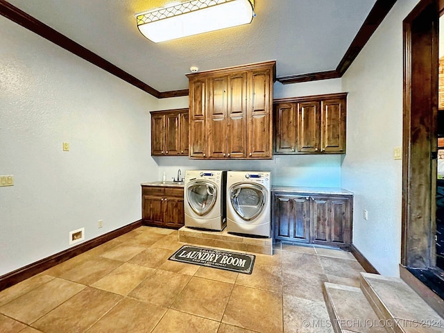 washroom featuring cabinets, crown molding, light tile patterned floors, washing machine and dryer, and sink