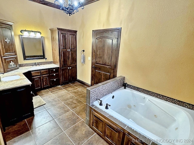 bathroom featuring vanity, a tub, tile patterned floors, and a notable chandelier