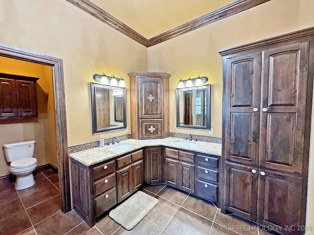 bathroom with tile patterned flooring, toilet, crown molding, and vanity