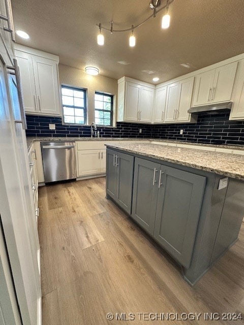 kitchen featuring white cabinets, gray cabinetry, light wood-type flooring, light stone countertops, and stainless steel dishwasher