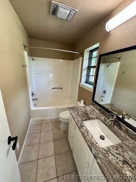 full bathroom featuring toilet, tile patterned flooring, vanity, a textured ceiling, and shower / bathtub combination