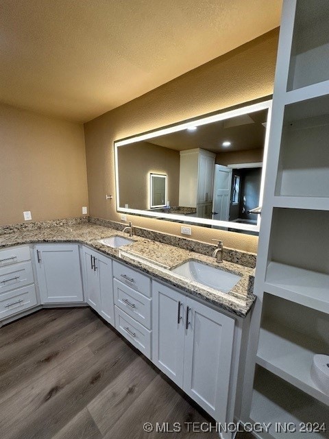 bathroom featuring hardwood / wood-style flooring, a textured ceiling, and vanity