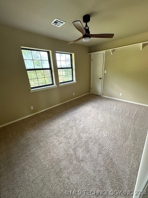 carpeted spare room with a textured ceiling and ceiling fan