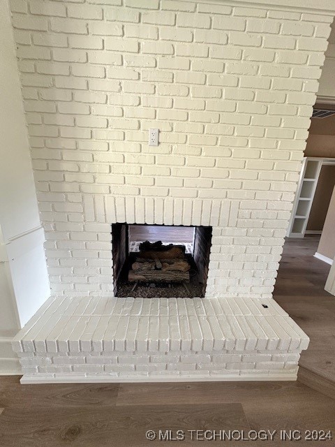 room details with a fireplace and wood-type flooring