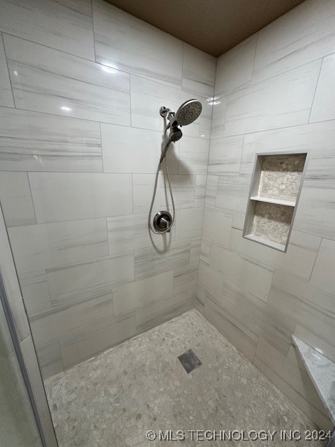 bathroom with tiled shower