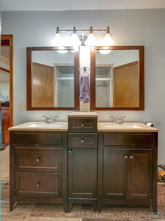 bathroom with vanity, wood-type flooring, and walk in shower