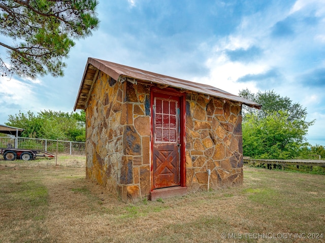 view of outbuilding with a lawn