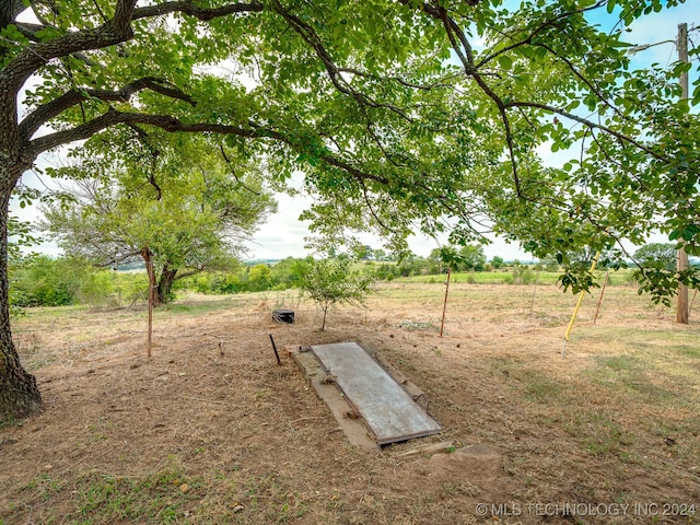 view of storm shelter featuring a rural view