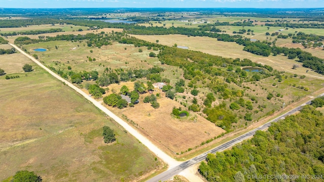 birds eye view of property featuring a rural view and a water view