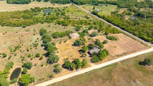 birds eye view of property with a water view and a rural view