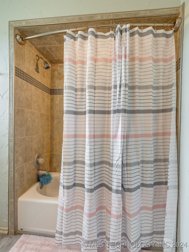 bathroom featuring shower / tub combo with curtain and hardwood / wood-style floors