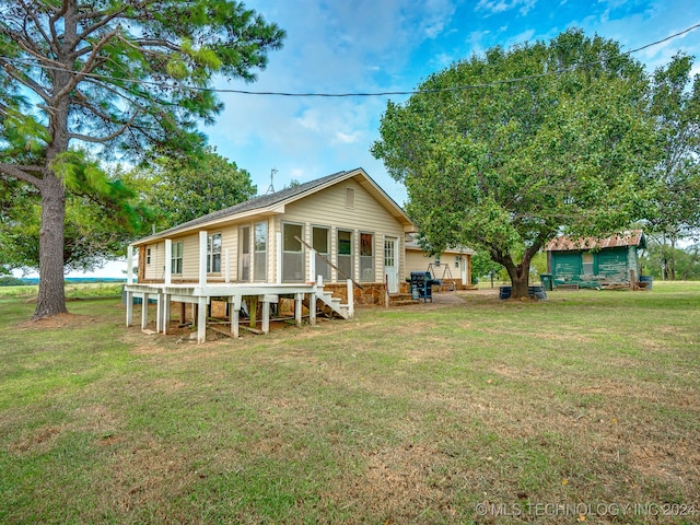 rear view of property with a yard