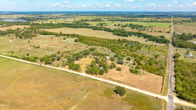 birds eye view of property featuring a water view and a rural view