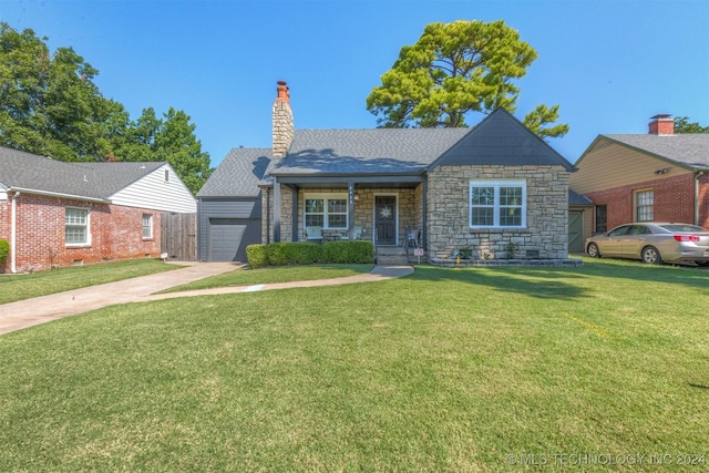 view of front of home featuring a front yard, roof with shingles, an attached garage, a chimney, and concrete driveway