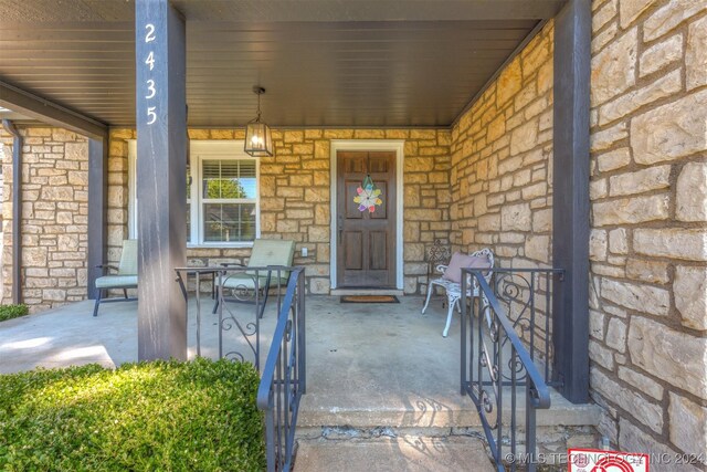 view of exterior entry with covered porch