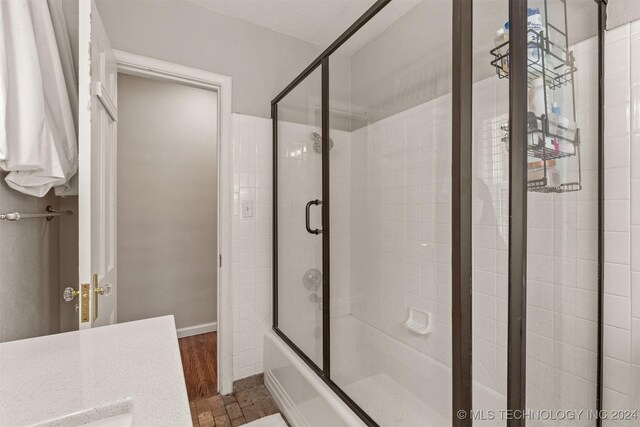 bathroom with shower / bath combination with glass door, vanity, and hardwood / wood-style flooring