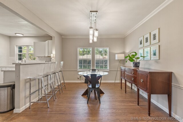 dining area featuring crown molding and dark hardwood / wood-style floors