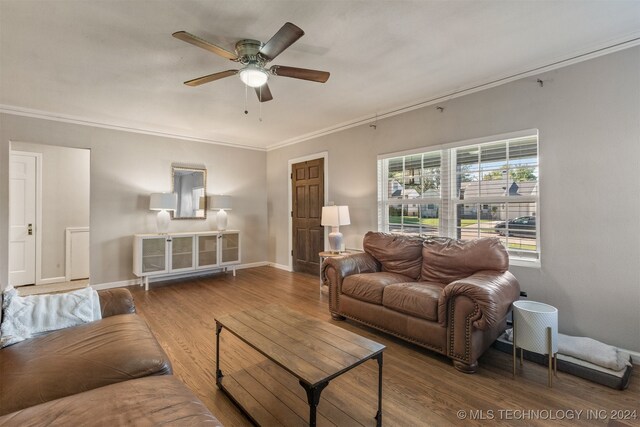 living room with ceiling fan, hardwood / wood-style flooring, and crown molding