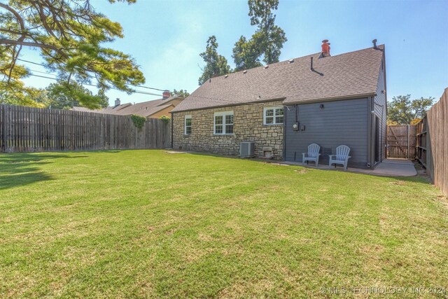 exterior space featuring central air condition unit, a yard, and a patio