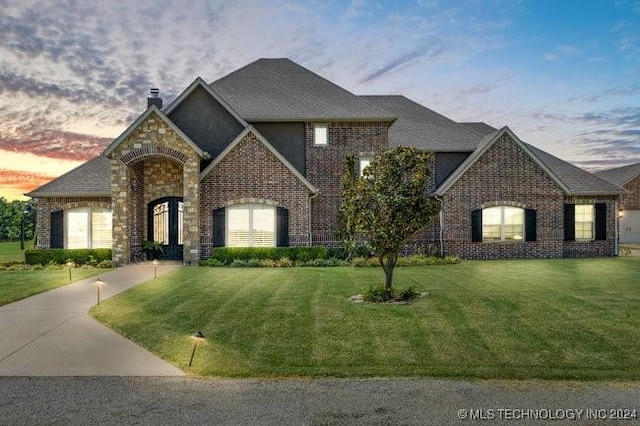 3526 Evans Ave, Mannford, OK 74044 - french country home with a chimney, a yard, and brick siding