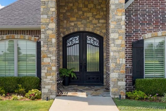 3526 Evans Ave, Mannford, OK 74044 - doorway to property with french doors, brick siding, and roof with shingles