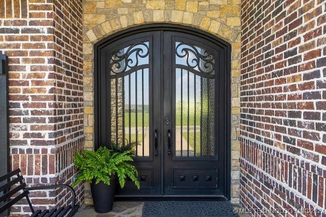 3526 Evans Ave, Mannford, OK 74044 - doorway to property with french doors and brick siding