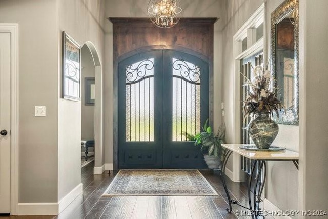 3526 Evans Ave, Mannford, OK 74044 - entrance foyer with french doors, arched walkways, a chandelier, baseboards, and hardwood / wood-style flooring