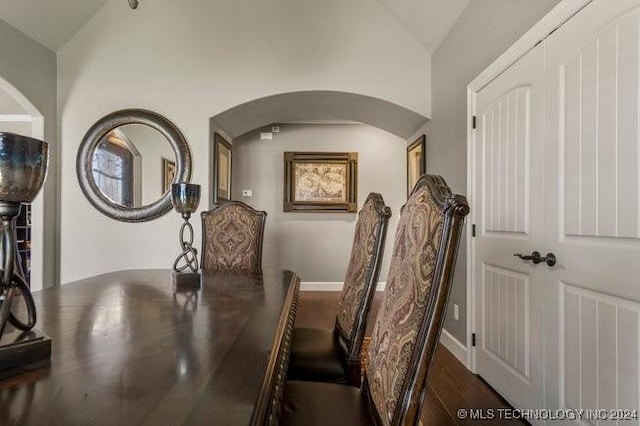 3526 Evans Ave, Mannford, OK 74044 - dining space featuring arched walkways, vaulted ceiling, and wood finished floors